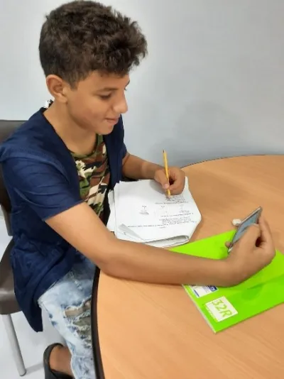 Rami, a Syrian refugee is studying remotely on Whatsapp
