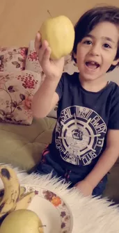 A child is playing with fruits