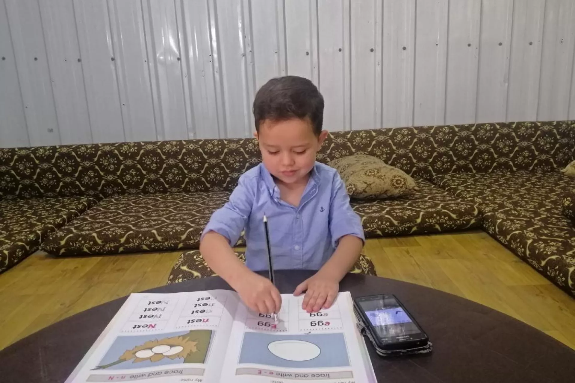 A young boy doing his homework from home