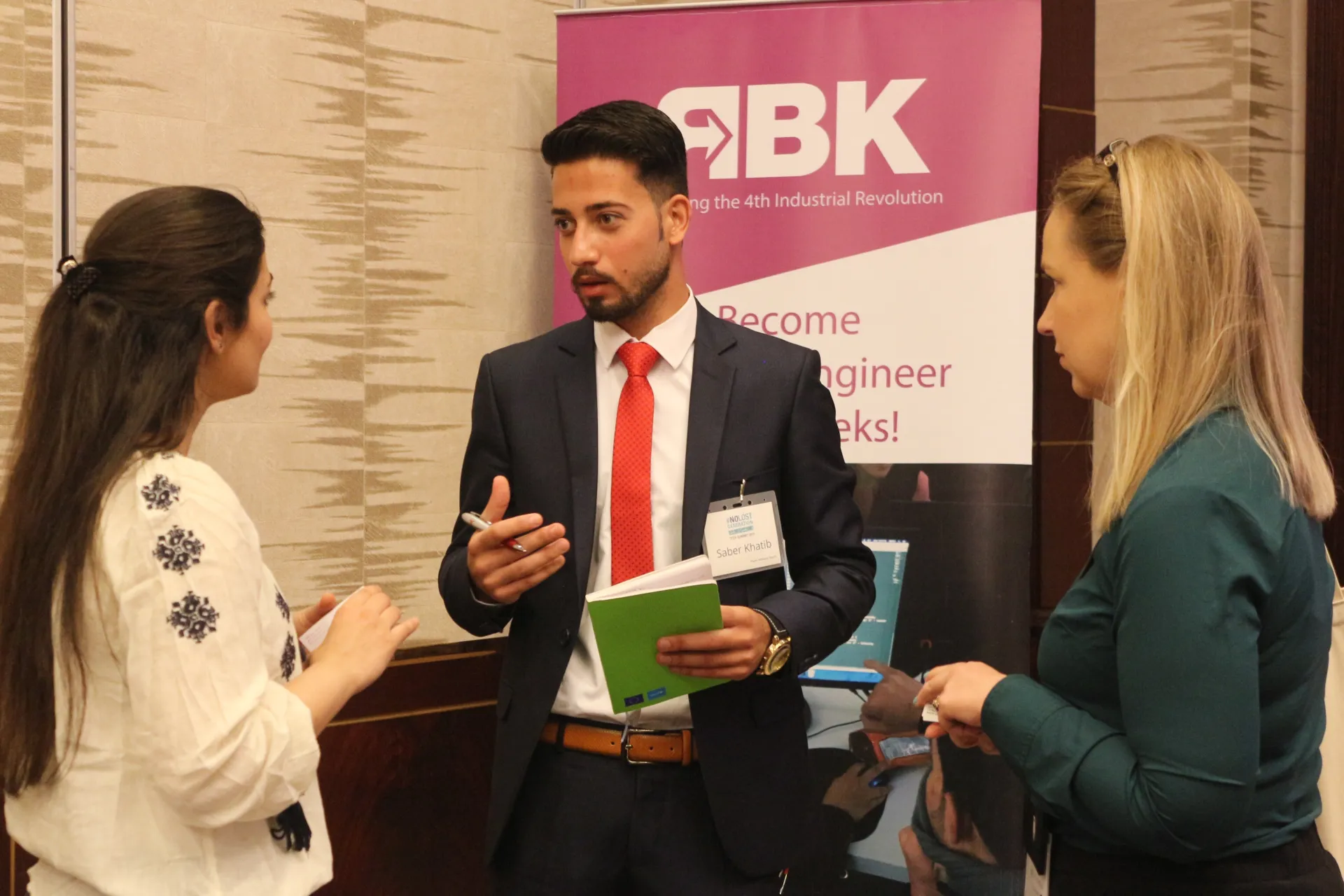 Three NLG Tech Summit participants having a discussion 