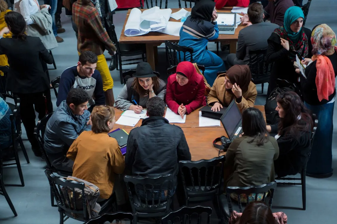 A table of young men and women brainstorming