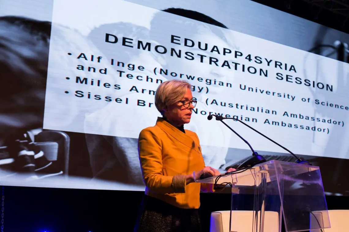 A woman presenting a powerpoint untitled "EDUAPP4Syria Demonstration Session"