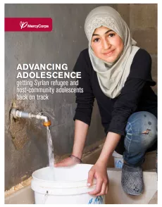 The cover of the report shows a picture of a teenage girl filling a bucket with water. The title "Advancing adolescence: getting Syrian refugee and host-community adolescents back on track" is on the left center of the page with Mercy Corps logo on top in a dark red banner